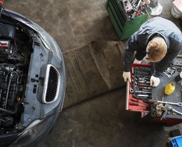 top-view-man-repairing-car
