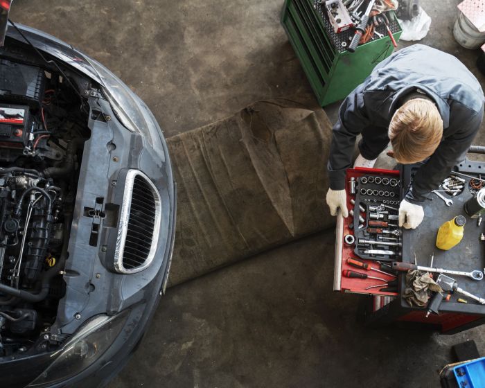 top-view-man-repairing-car