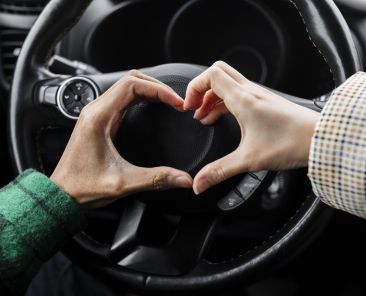 young-couple-traveling-with-car-close-up-doing-heart-shape