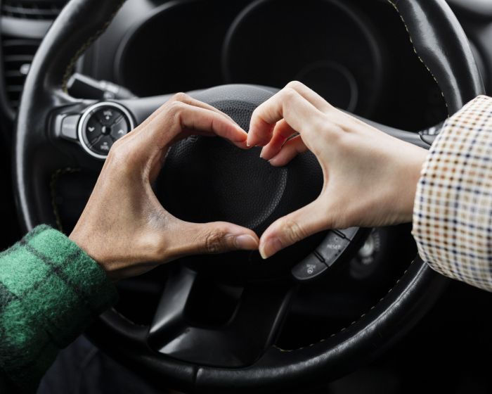 young-couple-traveling-with-car-close-up-doing-heart-shape