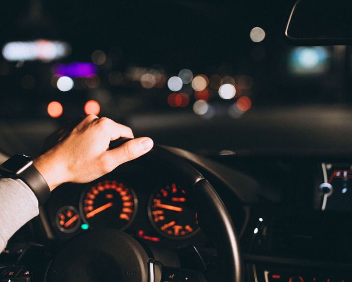 Young man driving his car at a night time